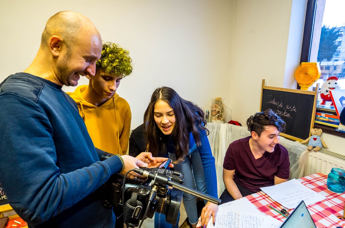 A group of people looking at a camera

Description automatically generated with low confidence