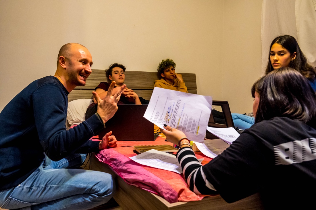 A group of people sitting at a table looking at a paper

Description automatically generated with low confidence